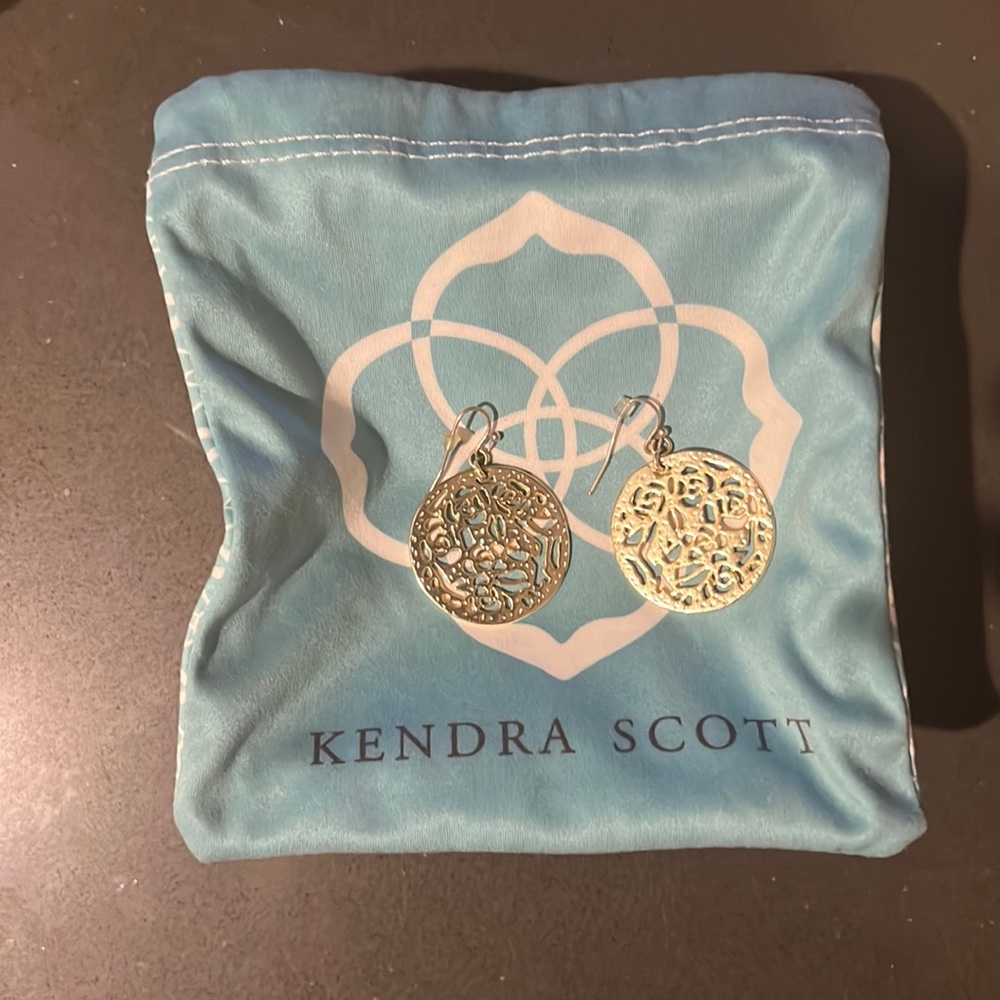 Golden Kendra Scott, dangle earrings, circular shape with rose-like designs.